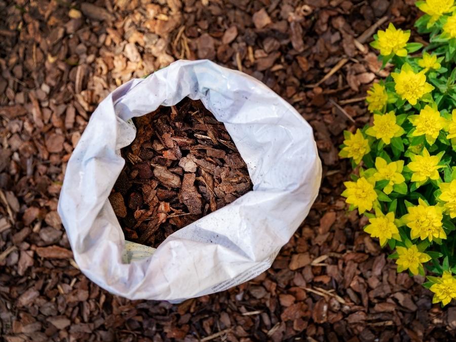 A bag of red mulch. 