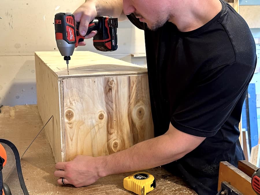 Arthur drilling pilot holes into the nesting boxes. 