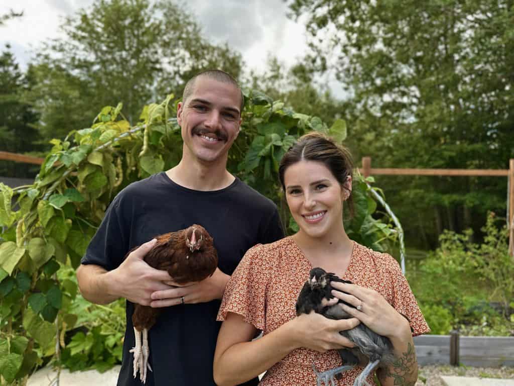 Arthur and Julia Fox, Owners and authors of Homestead Fox holding their two chickens. 