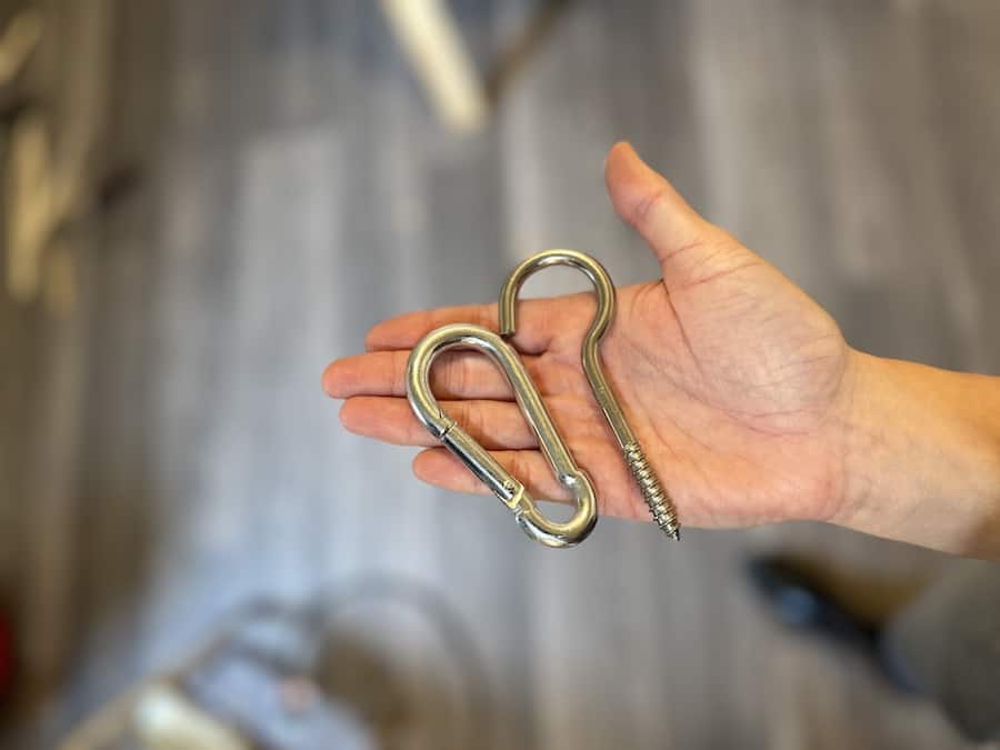 A carabiner and eyehook that were used to hang up the chicken coop waterer and feeder.