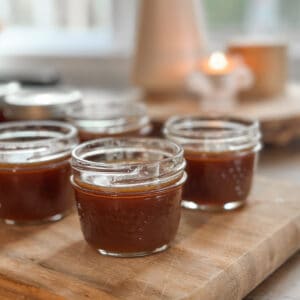 Small mason jars filled with homemade caramel.