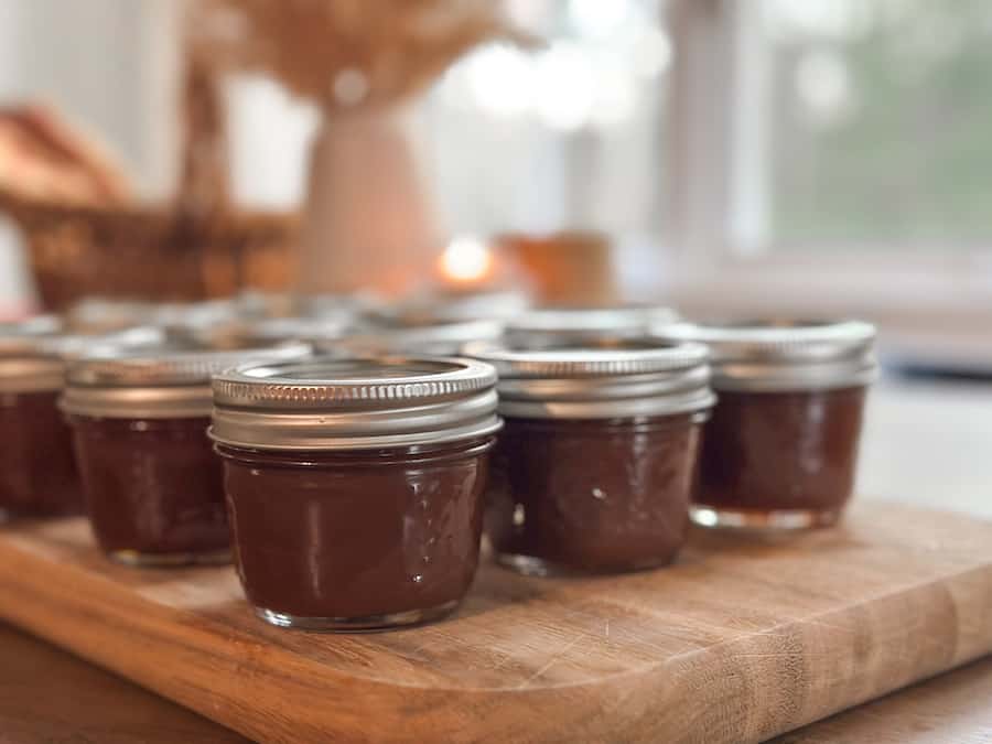 Small jars of dark homemade salted caramel.