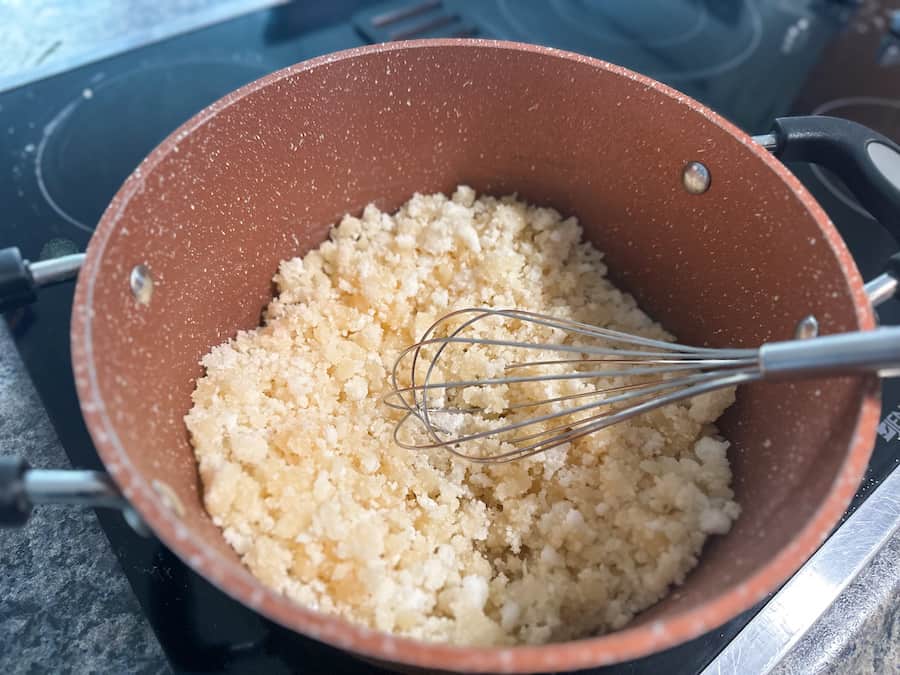 Sugar beginning to clump together while making homemade salted caramel.