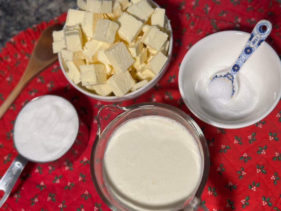 Homemade salted caramel ingredients pre-measured and prepped. The photo includes: Granulated sugar, whipping cream, sea salt and unsalted butter.