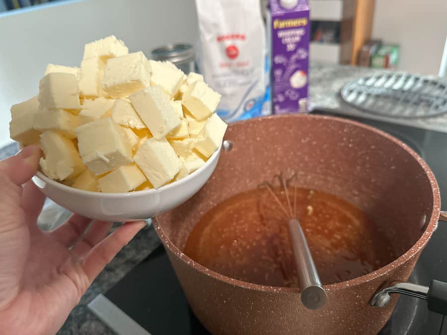 Butter in a bowl about to be added to the pot to make homemade salted caramel.