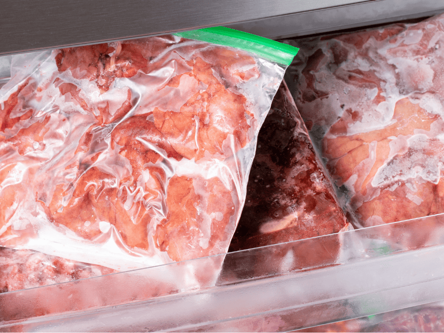 Frozen meat in a freezer in ziplock bags. 