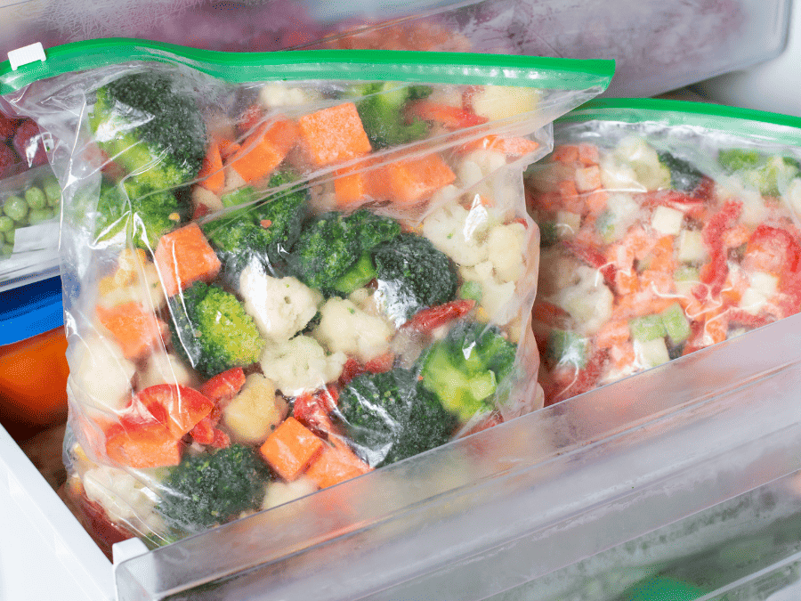 Blanched medley of vegetables including carrots, broccoli, cauliflower in the freezer. 