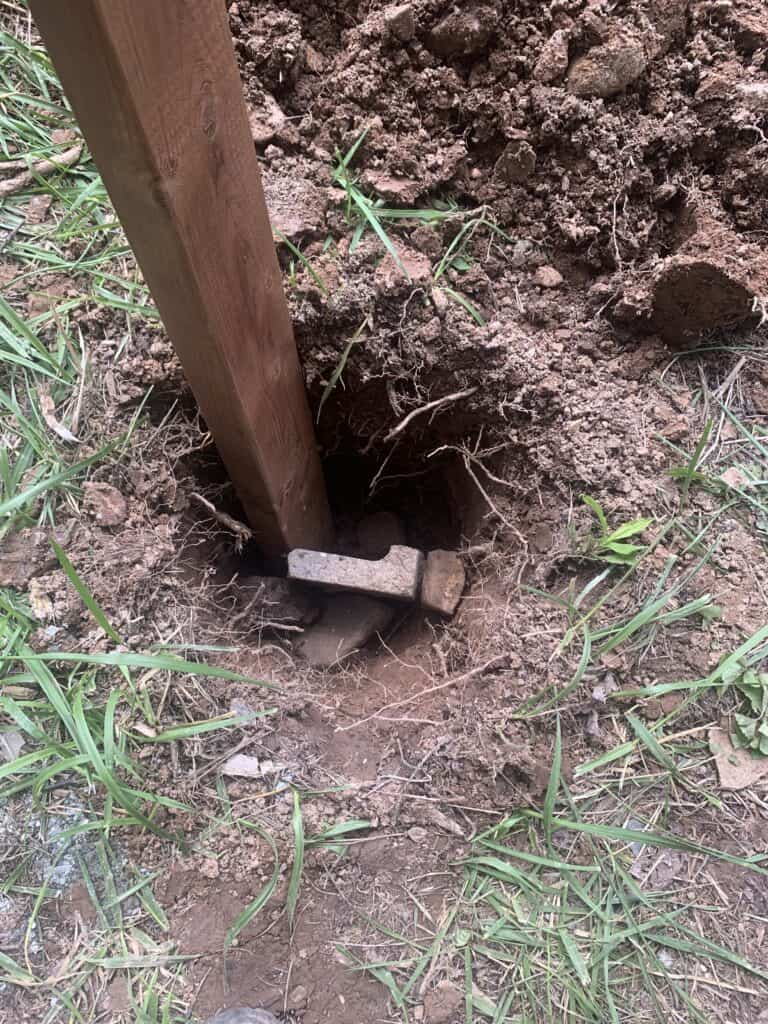 Hole in the ground with a wood in it for the chicken run 